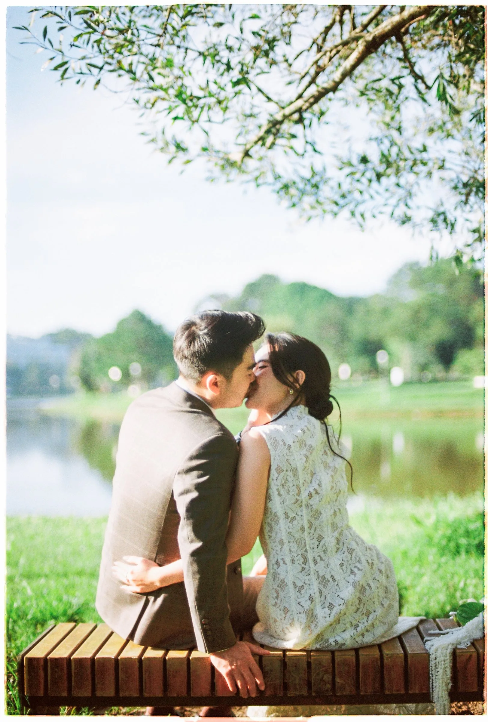 A quiet film pre-wedding by the lake in Da Lat with Binh and Ha, shot on 35mm.
