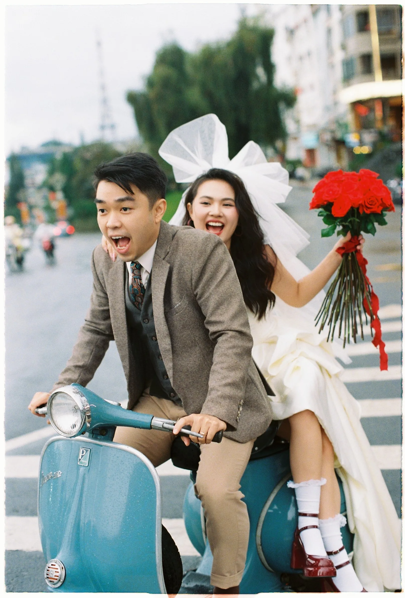 No posing, just the two of them laughing on a Vespa in the Da Lat rain. This is what film does best.