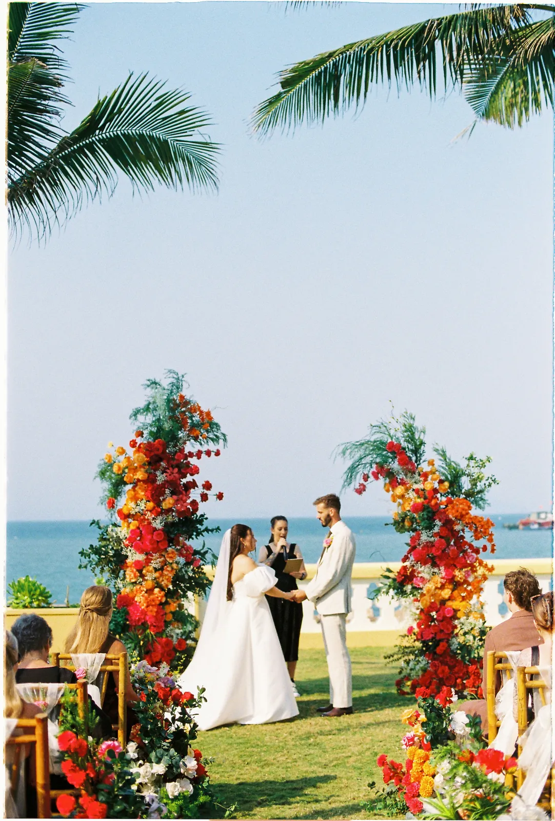 Floral ceremony arch overlooking the sea at Victoria Hoi An Beach Resort, on film