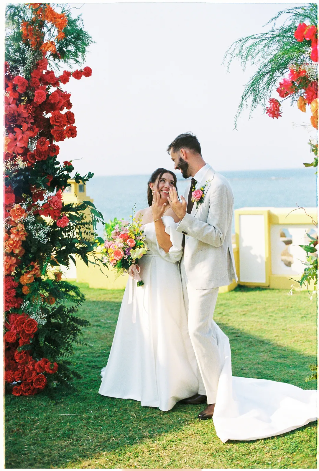 Bride and groom by the sea at their Victoria Hoi An destination wedding, on 35mm film
