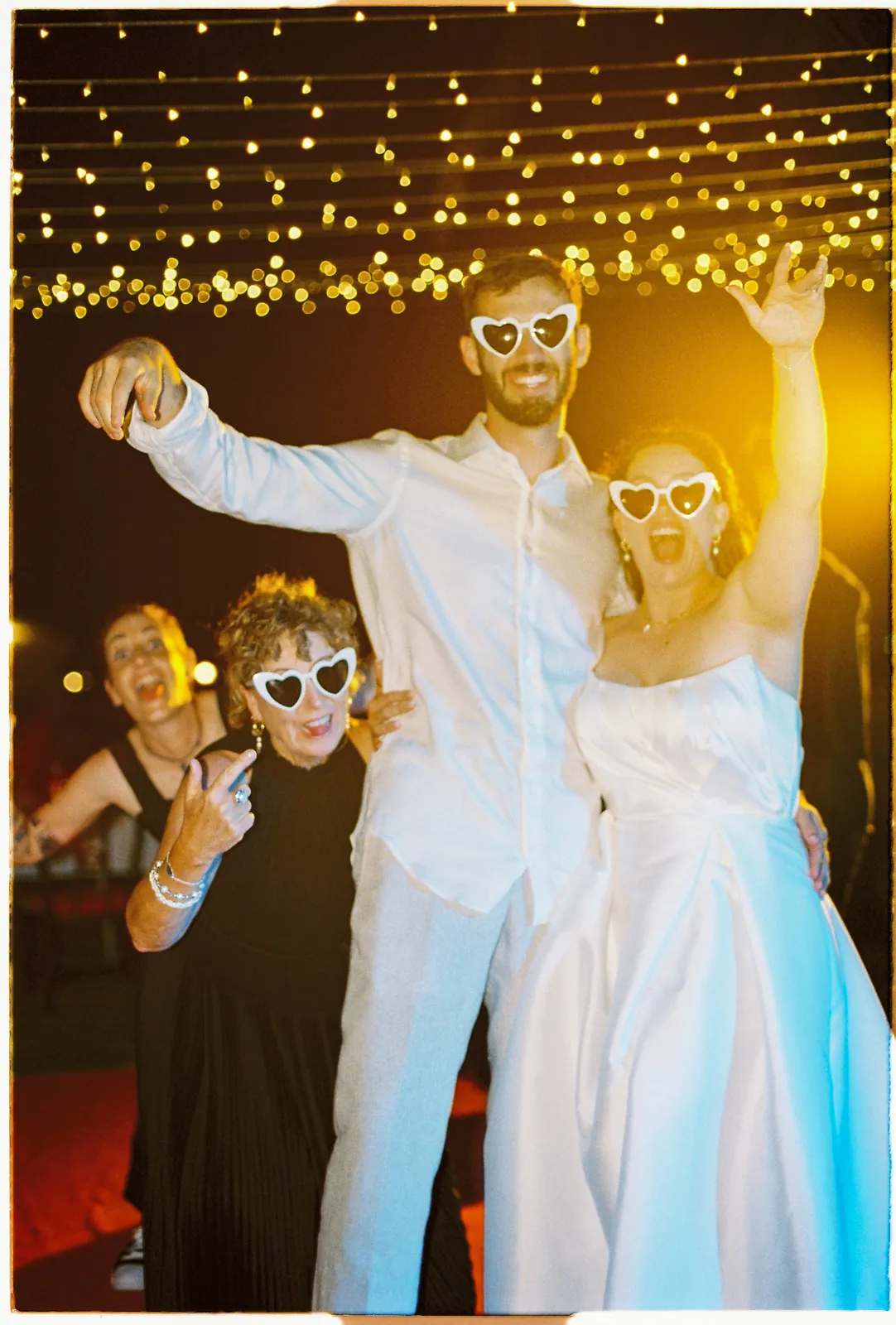Night reception under fairy lights at a Hoi An wedding, on 35mm film
