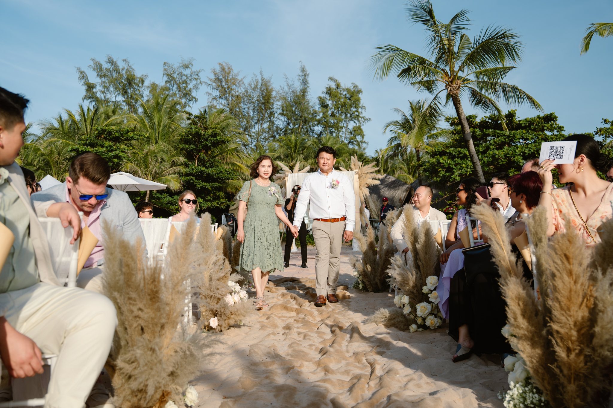 A pampas-lined wedding aisle leading down to the sea at a Phu Quoc beach wedding, InterContinental Phu Quoc