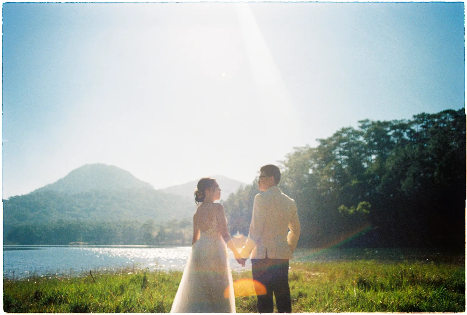 A couple at first light on a Da Lat lake during their elopement.