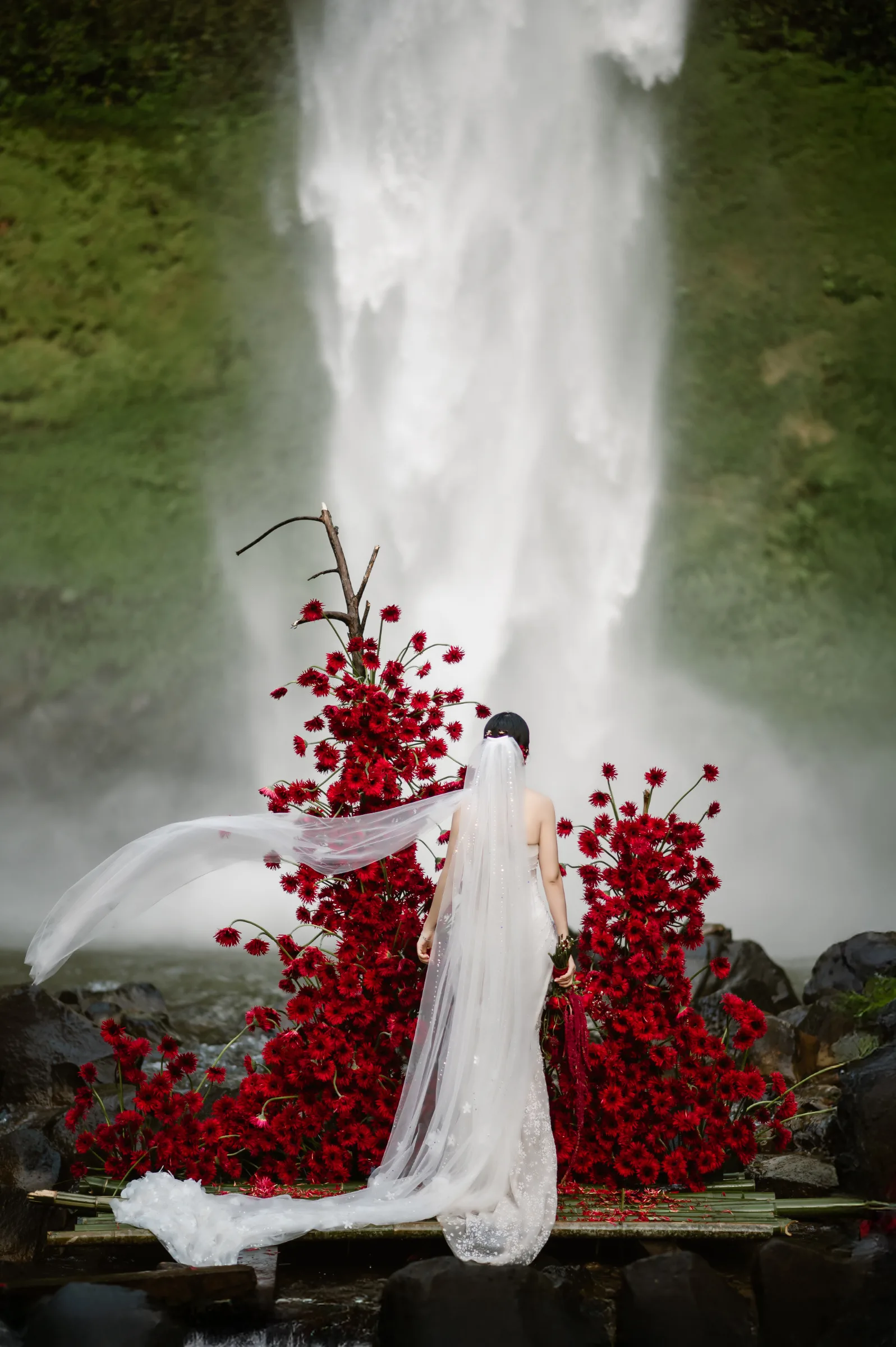 Bold florals bring colour to the wild scenery of a waterfall elopement.